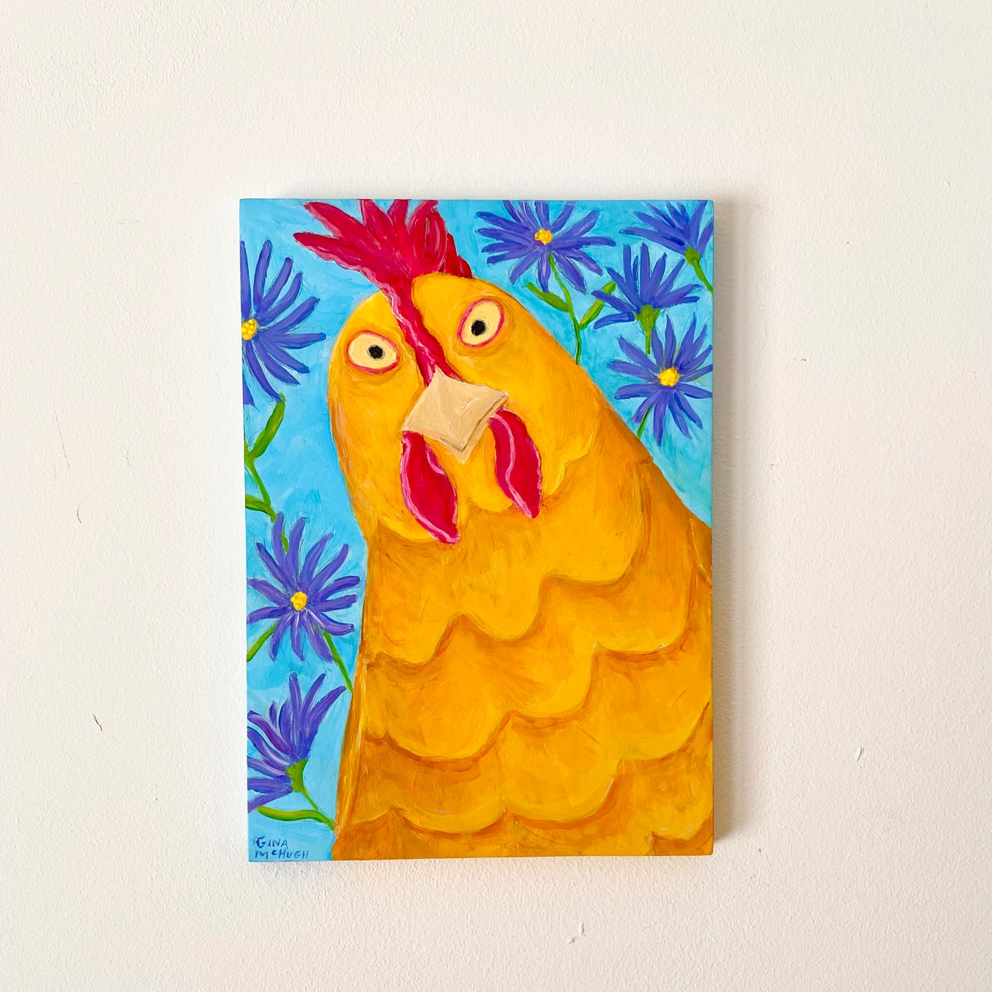 Painting of a chicken with a blue floral background on a white wall