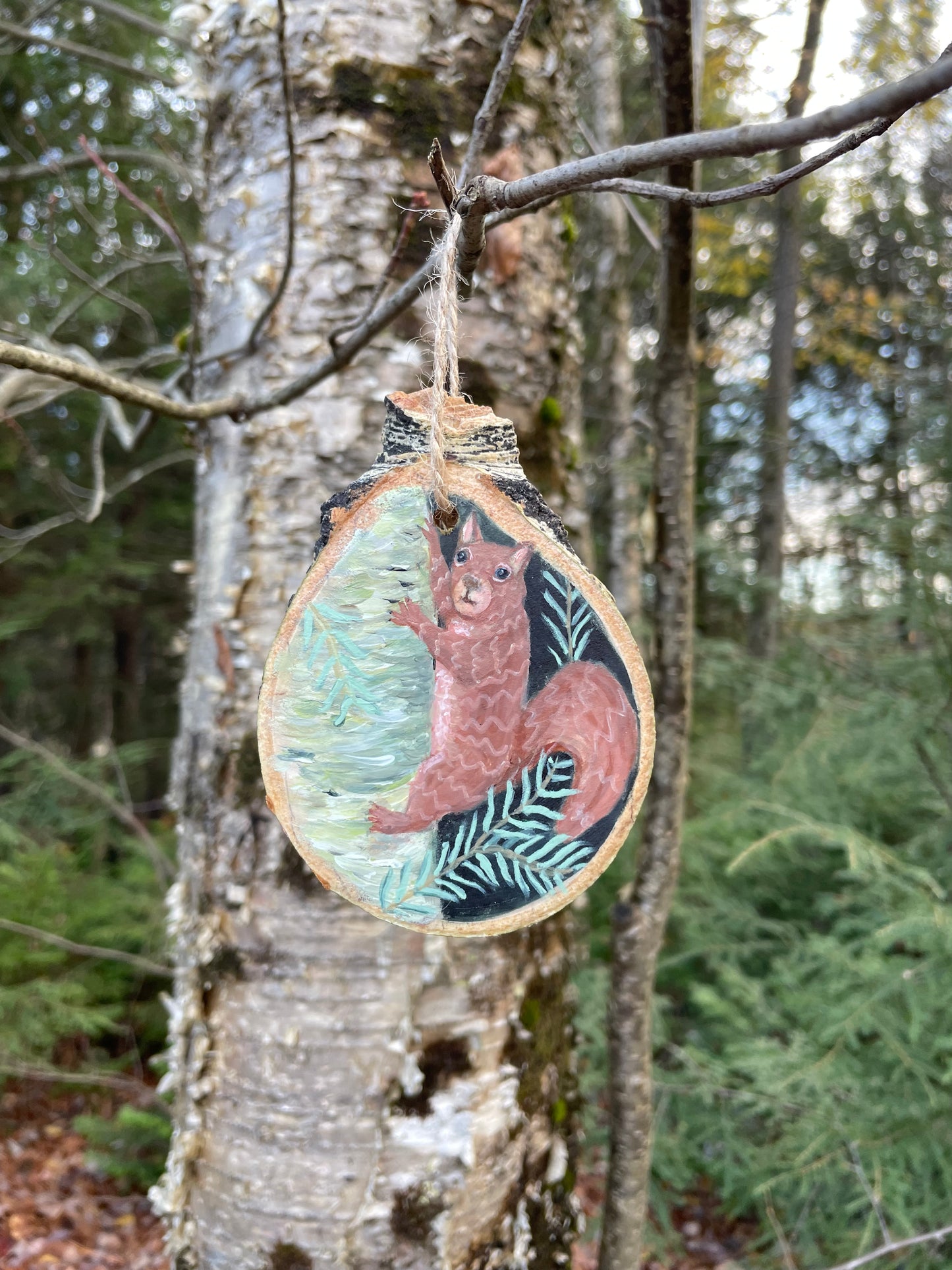 Decorative ornament with a squirrel design on a branch