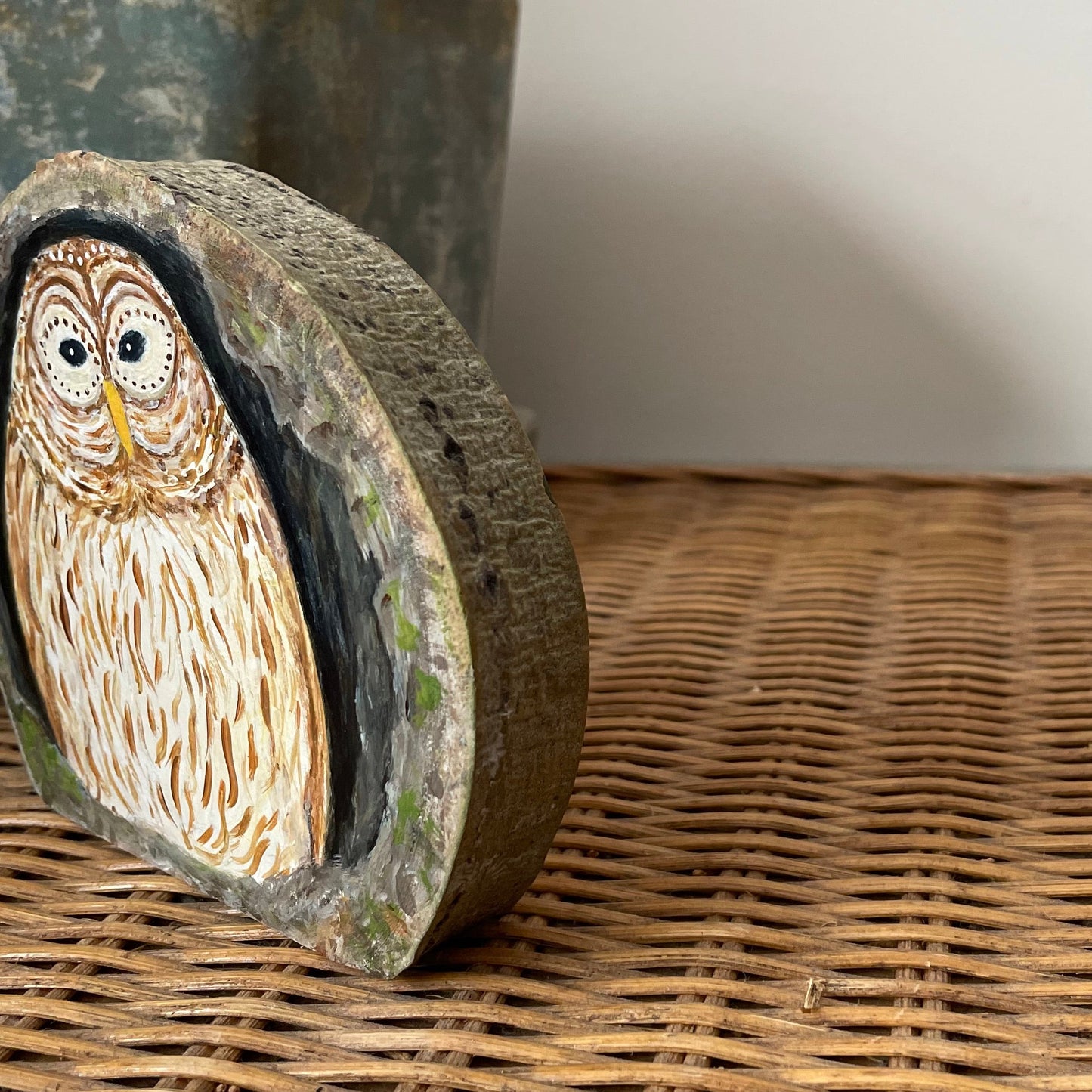 Painting of a nesting barred owl inside a tree cavity on a freestanding aspen wood slice