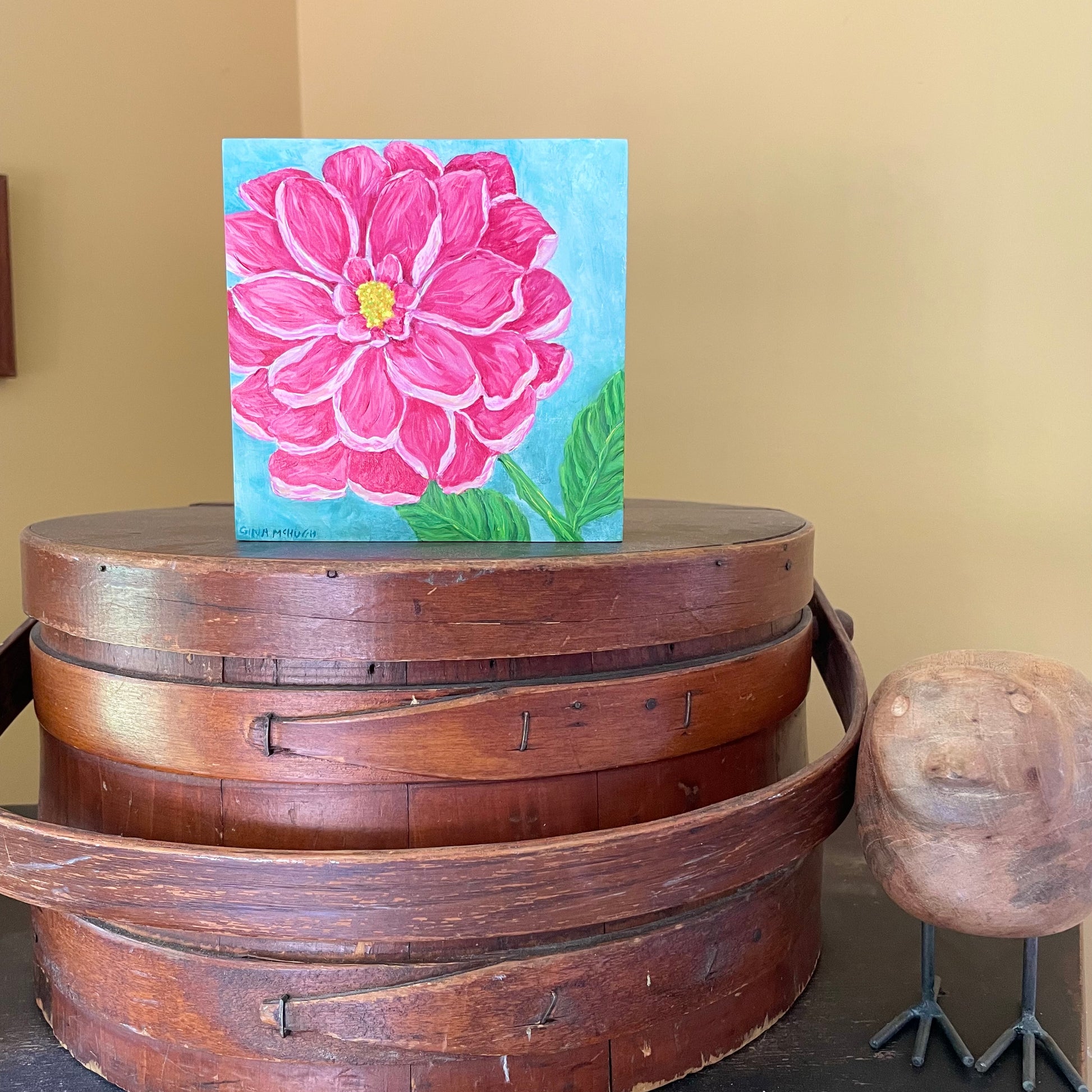 Painting of a pink dahlia flower on a cradled wood panel  on a mantle