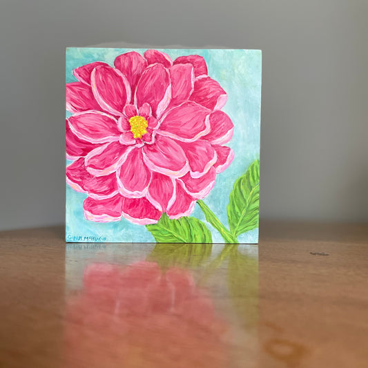 Painting of a pink dahlia flower  on a wooden surface
