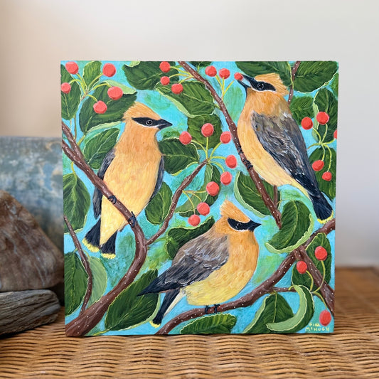 A bright and cheerful Painting of Three cedar waxwing birds among serviceberry branches 