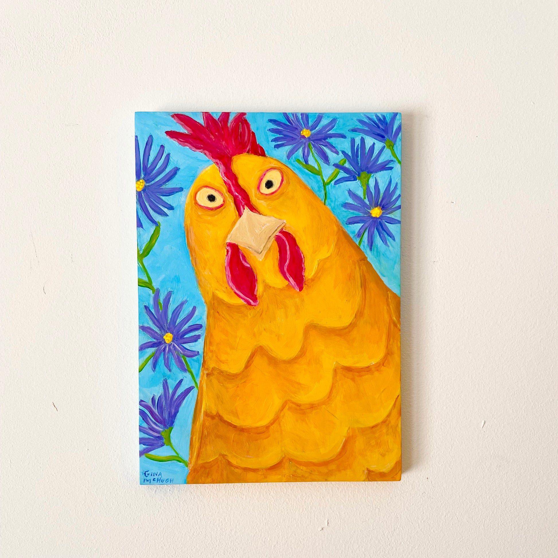 Painting of a chicken with a blue floral background on a white wall