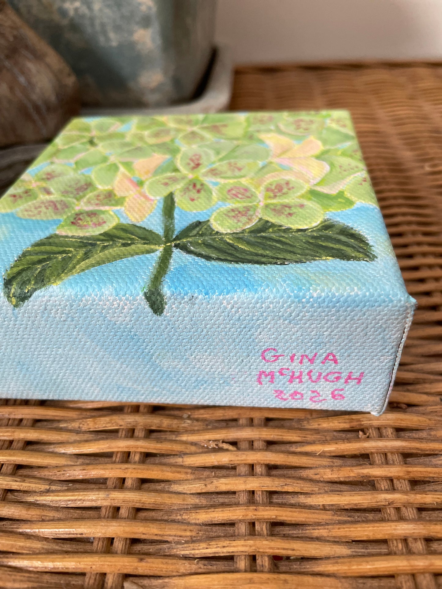 Hydrangea paintings in blue-purple, pink, and green
