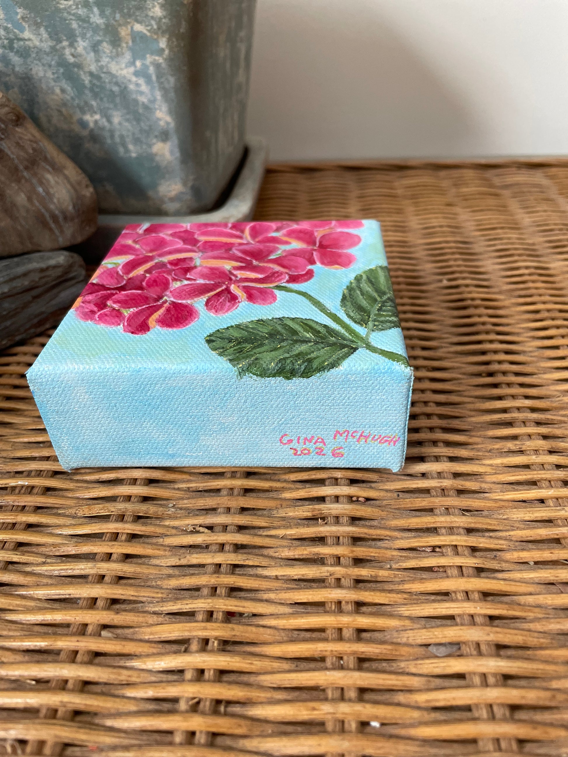 Hydrangea paintings in blue-purple, pink, and green