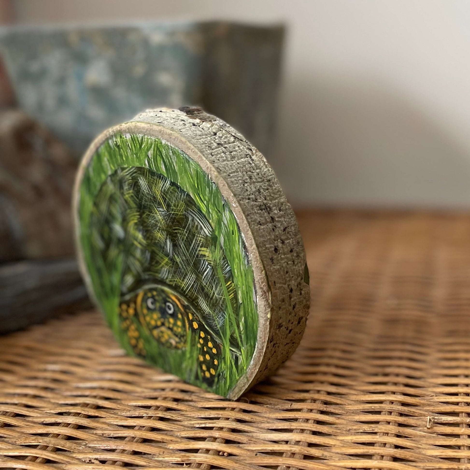 Painting of a wood  turtle in grass on freestanding aspen wood slice