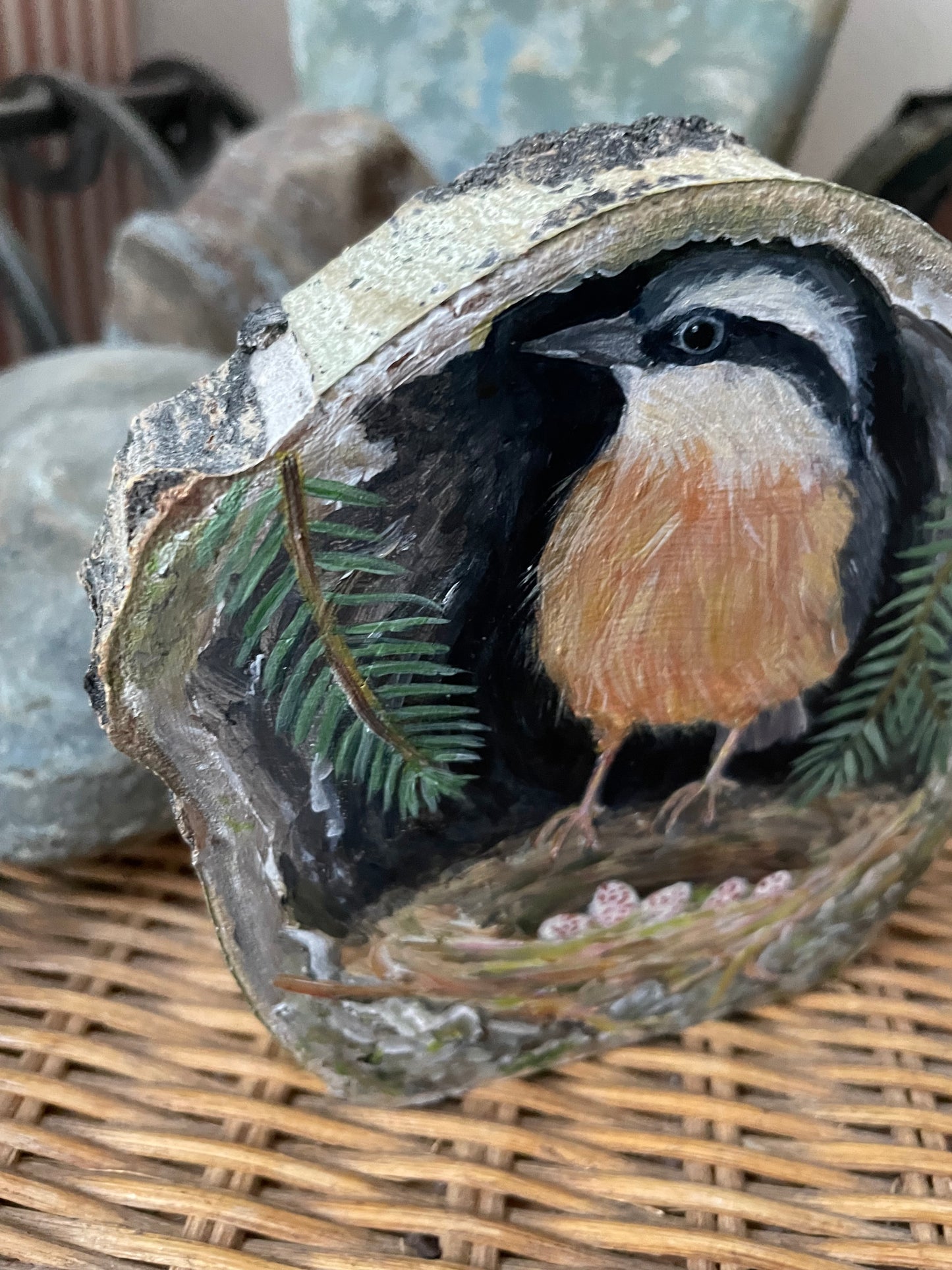 Painting of a Red-breasted Nuthatch on a next inside a tree cavity with pine branches on a freestanding aspen wood slice