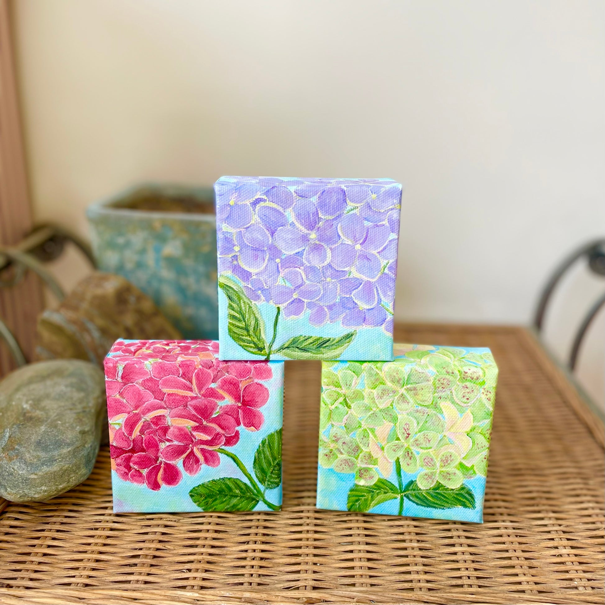 Hydrangea paintings in blue-purple, pink, and green