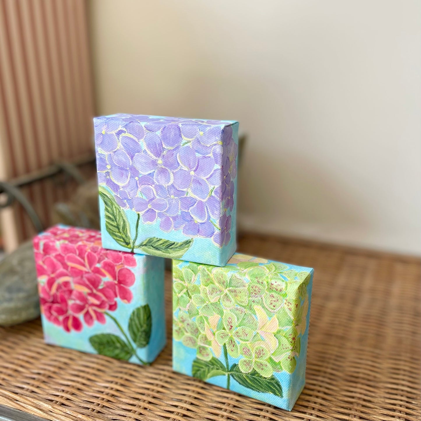 Hydrangea paintings in blue-purple, pink, and green