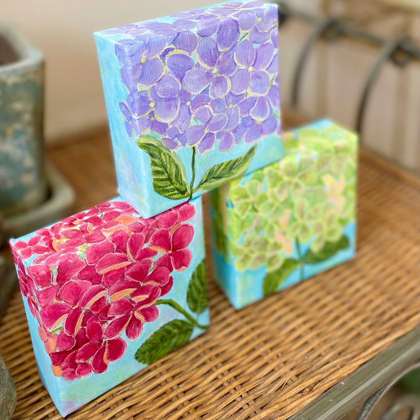 Hydrangea paintings in blue-purple, pink, and green, 
