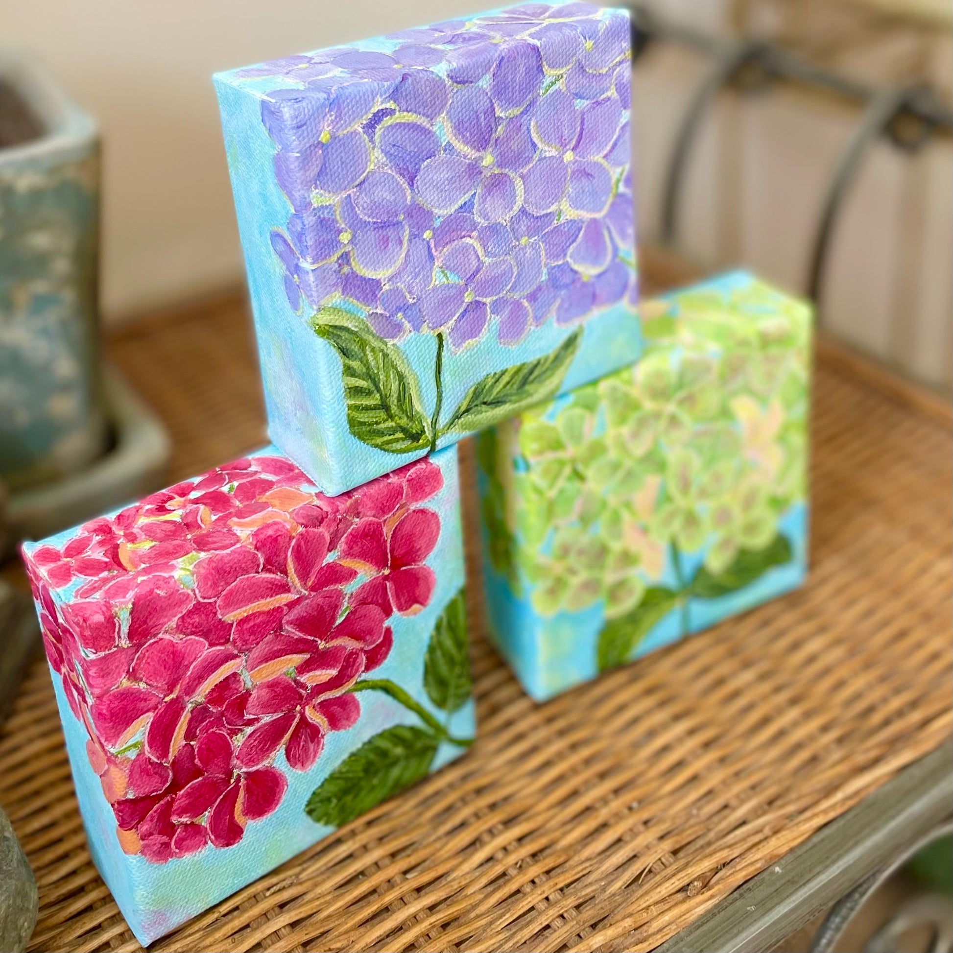 Hydrangea paintings in blue-purple, pink, and green, 