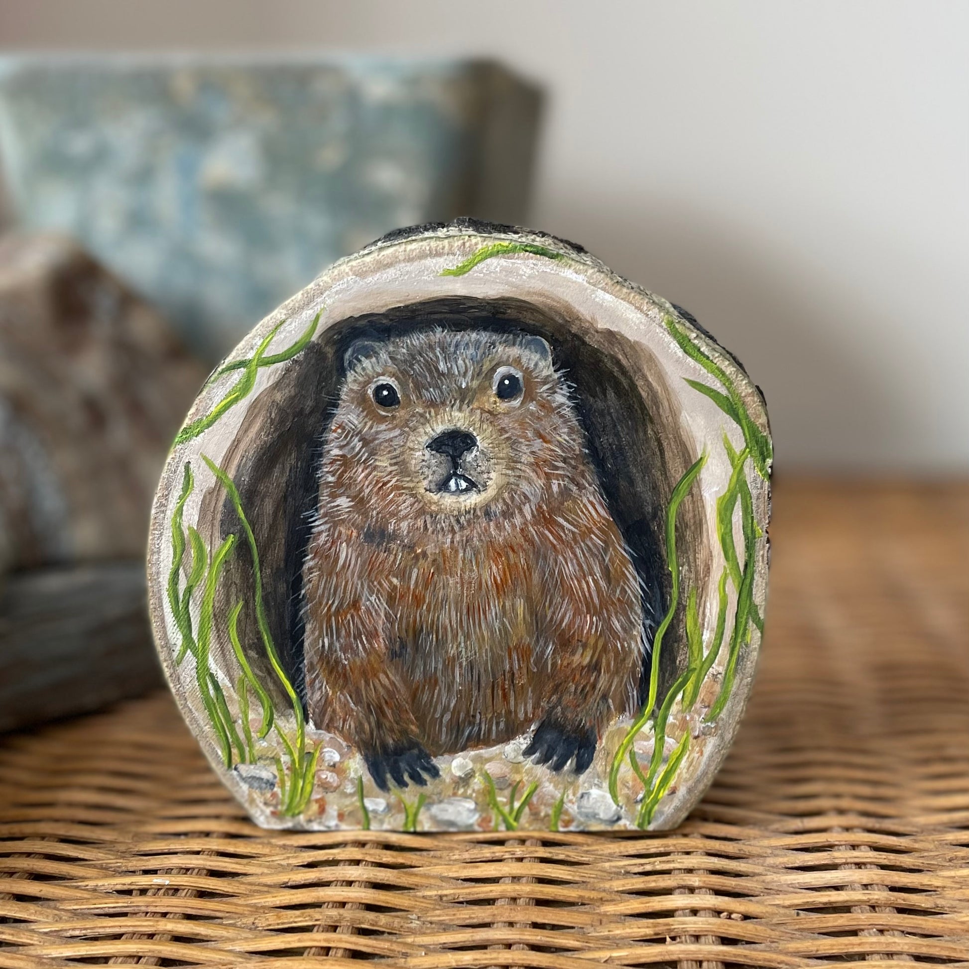 Painting of a Groundhog woodchuck looking out from its burrow