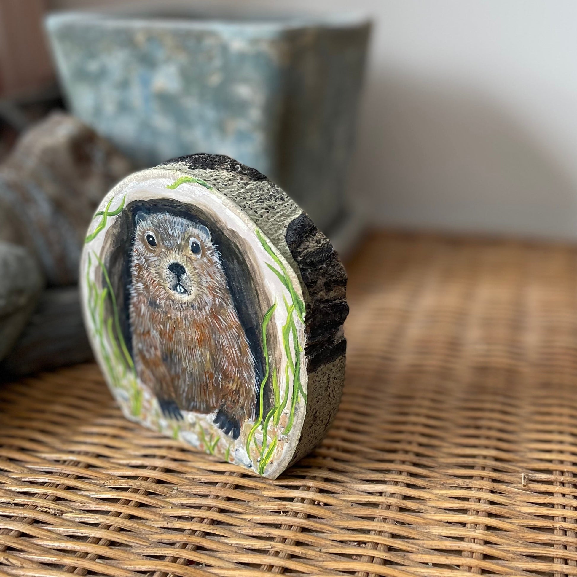 Painting of a Groundhog woodchuck looking out from its burrow