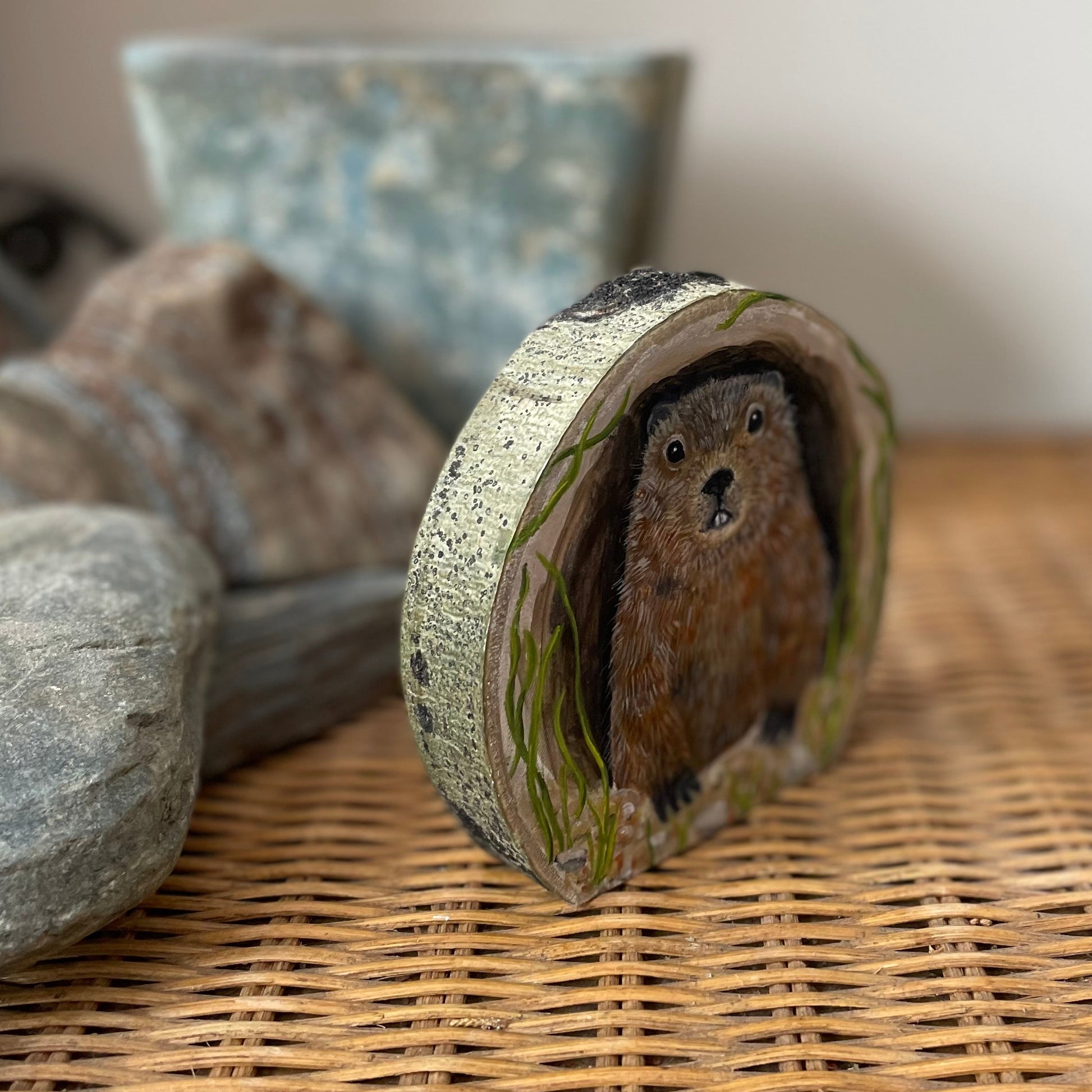 Painting of a Groundhog woodchuck looking out from its burrow
