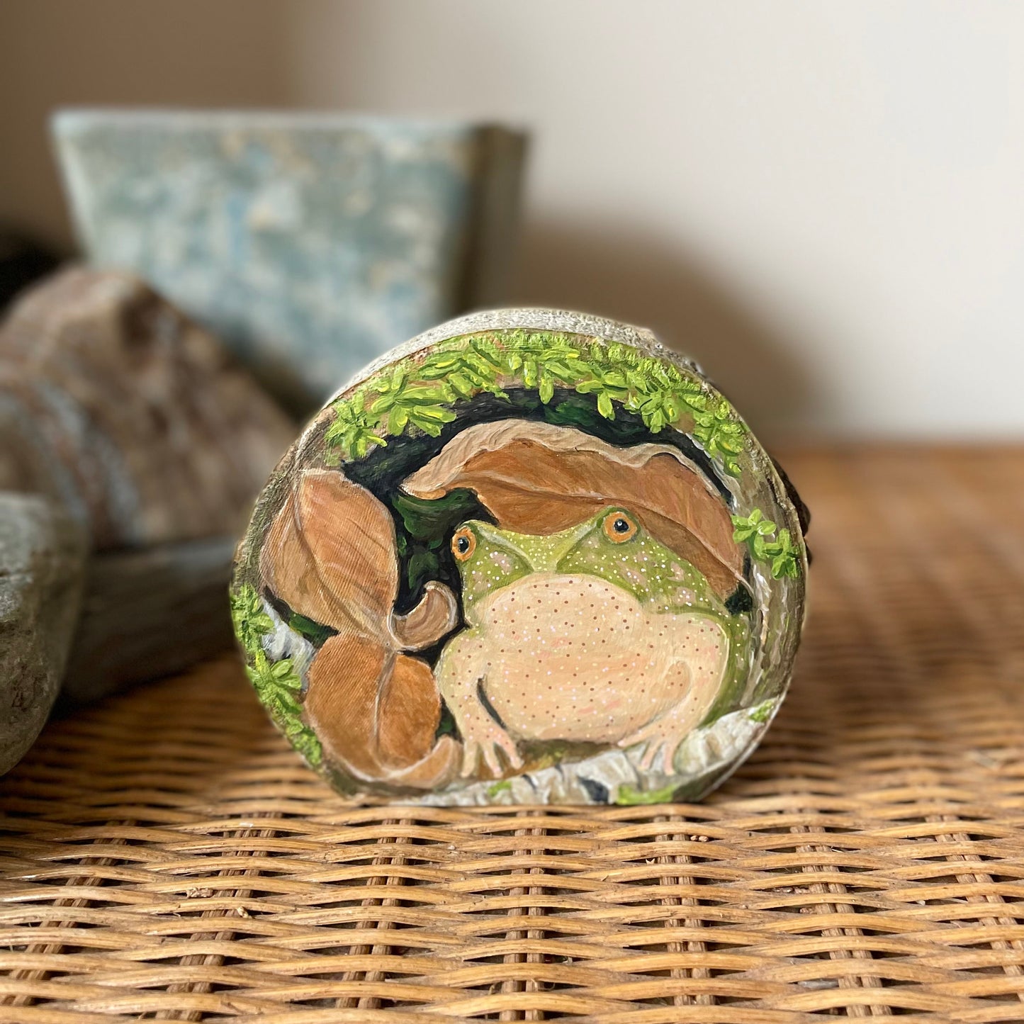 Spring peeper frog under a mossy log painted on freestanding aspen wood slice