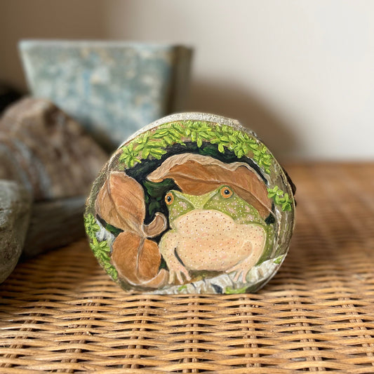 Spring peeper frog under a mossy log painted on freestanding aspen wood slice